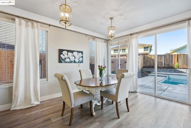 dining area with an inviting chandelier and hardwood / wood-style floors