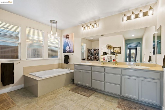 bathroom featuring vanity, tile patterned floors, and a tub