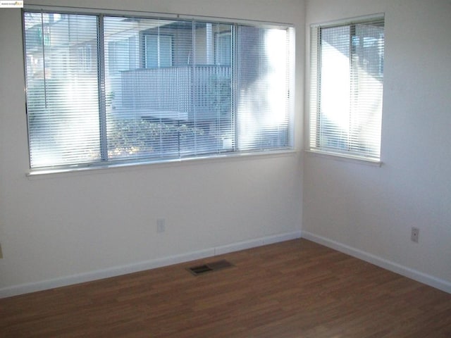 unfurnished room with wood-type flooring