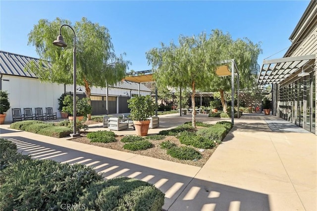 surrounding community with a pergola and a patio area