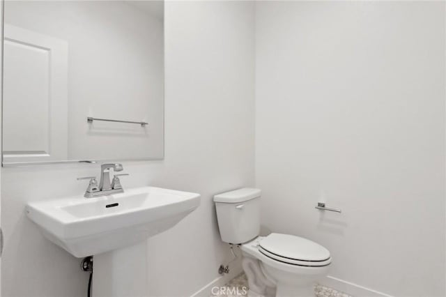 bathroom featuring sink and toilet