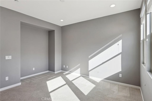 unfurnished room with light colored carpet