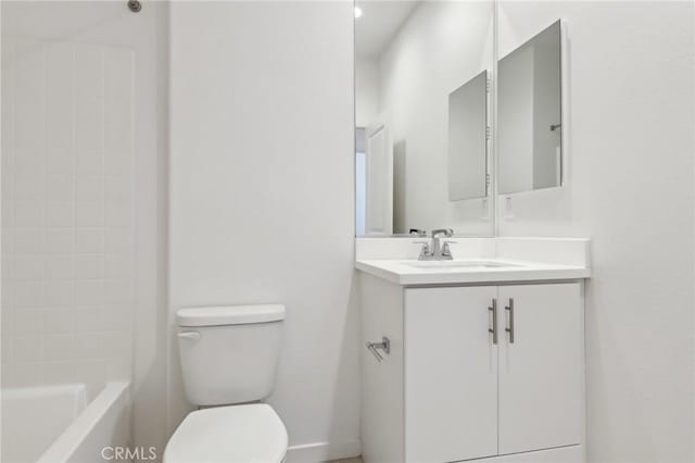 full bathroom with vanity, tiled shower / bath, and toilet