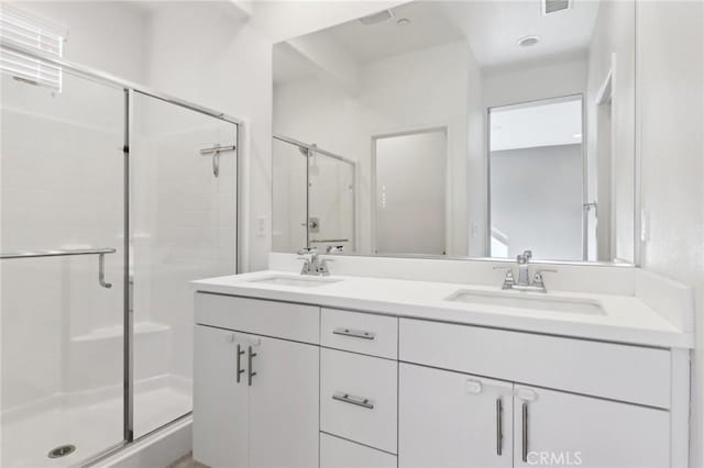 bathroom with an enclosed shower and vanity