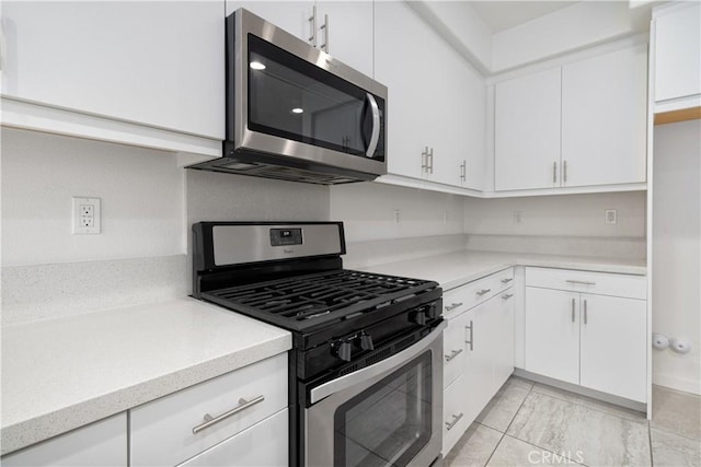 kitchen with white cabinetry and stainless steel appliances