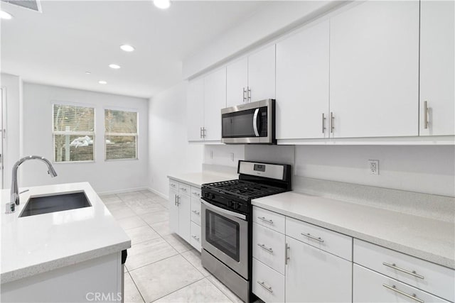 kitchen featuring sink, stainless steel appliances, and white cabinets