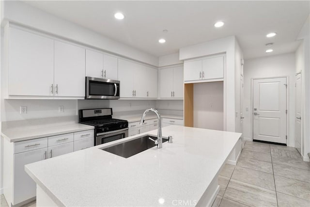 kitchen with white cabinetry, sink, a center island with sink, and appliances with stainless steel finishes