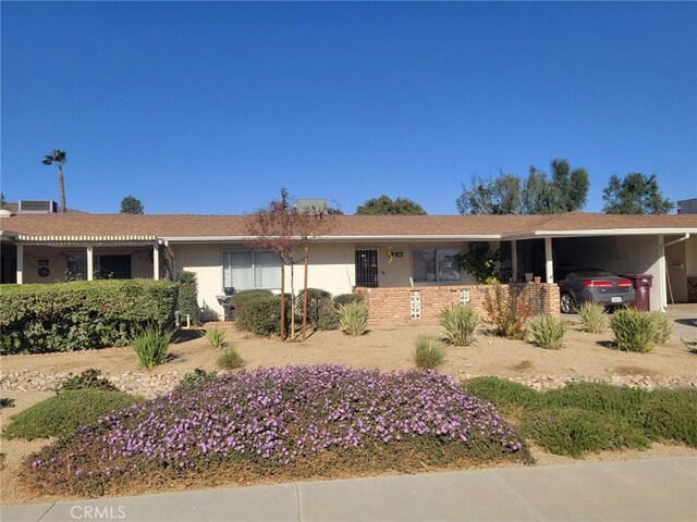 ranch-style house featuring a carport