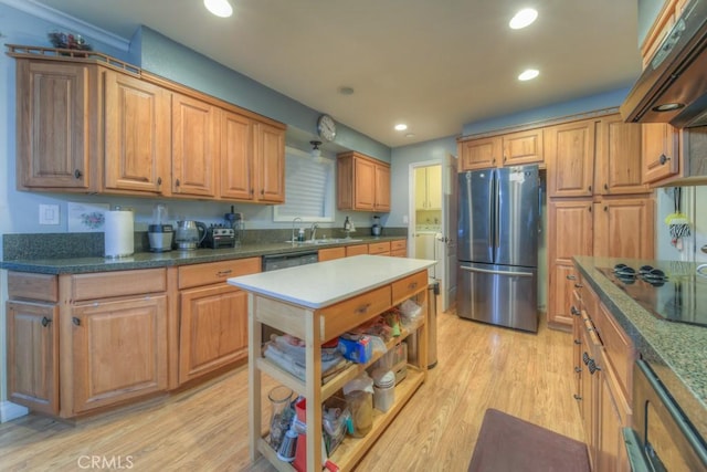 kitchen with sink, extractor fan, light hardwood / wood-style flooring, and black appliances