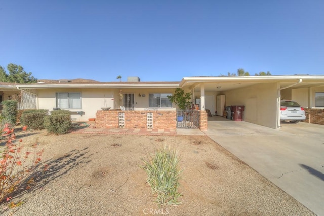 ranch-style home featuring a carport