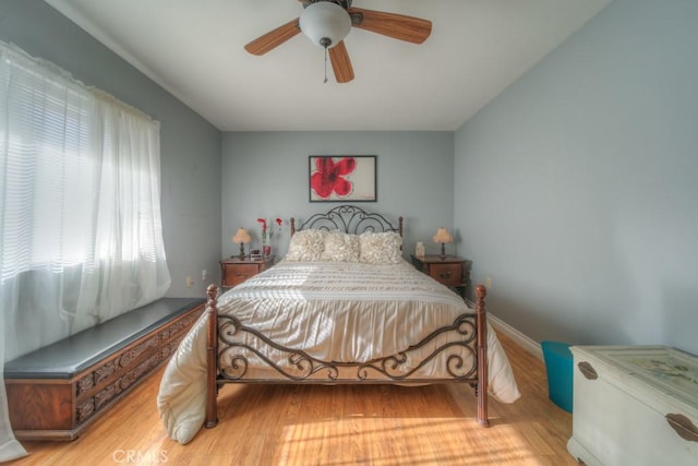 bedroom with ceiling fan and light hardwood / wood-style flooring