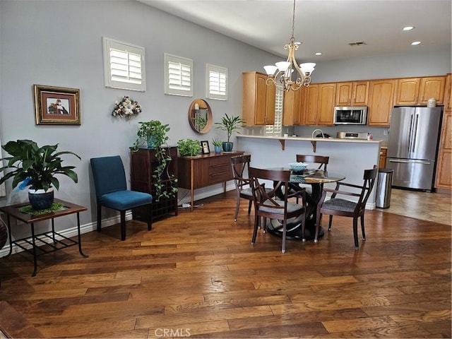 dining room with a chandelier and dark hardwood / wood-style flooring