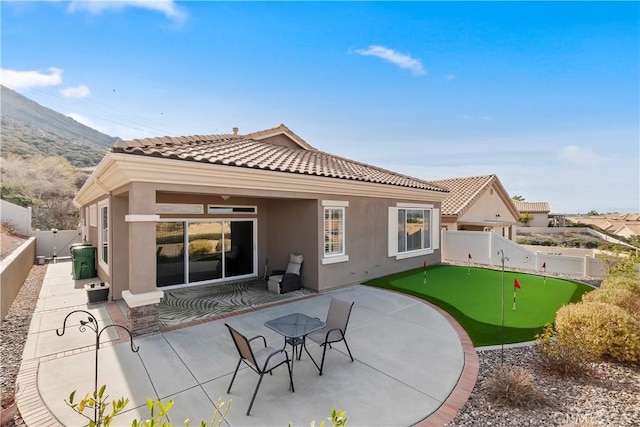 back of house with a patio and a mountain view