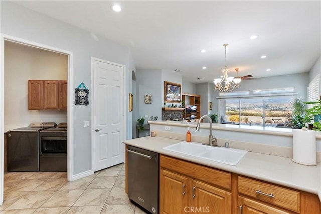 kitchen with dishwasher, sink, hanging light fixtures, a notable chandelier, and washer and clothes dryer