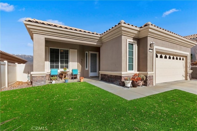 rear view of property with a garage and a lawn