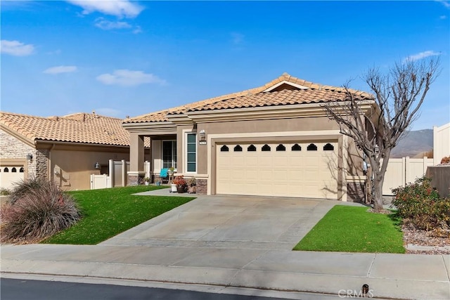 mediterranean / spanish house featuring a garage and a front lawn