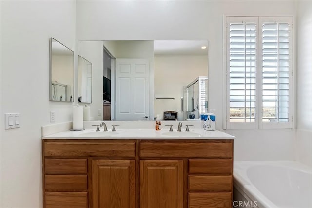 bathroom featuring vanity and shower with separate bathtub