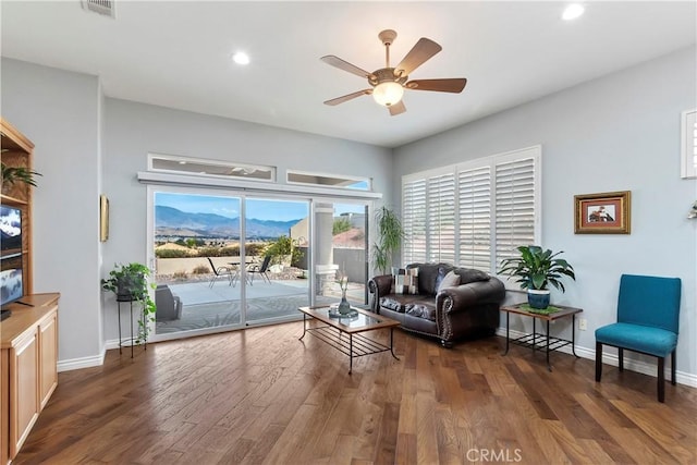 living room with dark hardwood / wood-style floors and ceiling fan