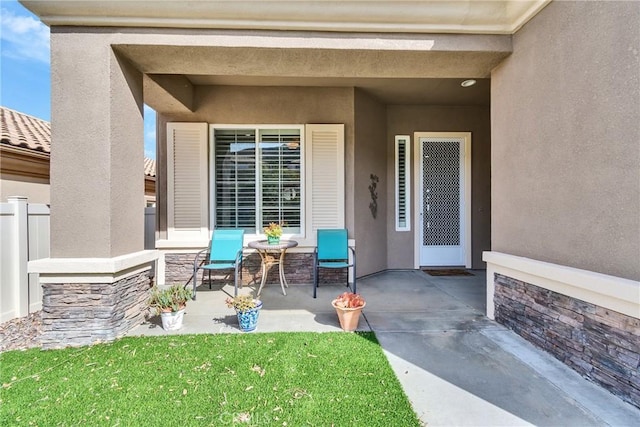 property entrance with a patio area