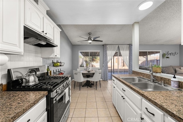 kitchen featuring sink, white cabinetry, a textured ceiling, and gas stove