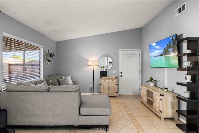 living room with light tile patterned floors and a textured ceiling