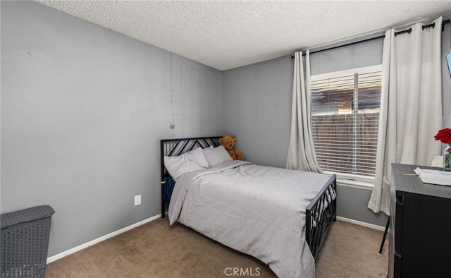 bedroom featuring carpet and a textured ceiling