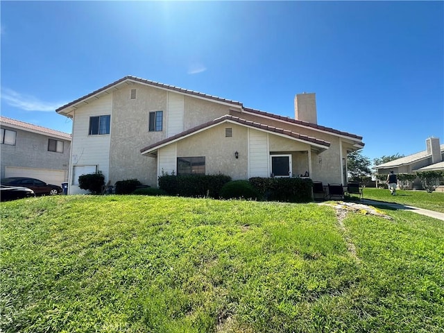 view of side of home with a garage and a yard