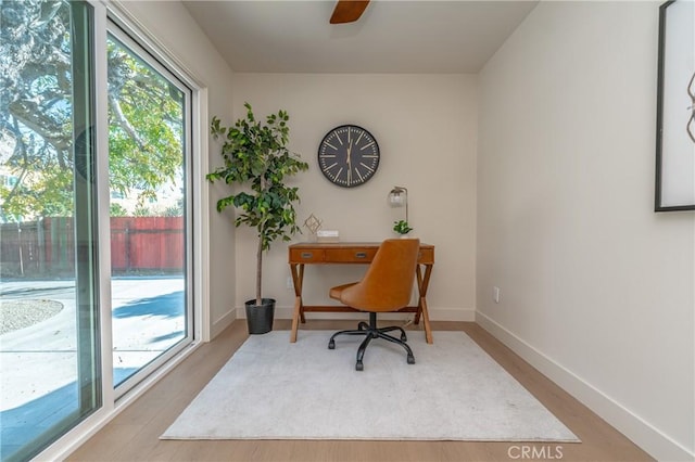 home office featuring ceiling fan and hardwood / wood-style floors