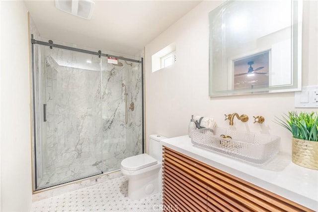 bathroom featuring toilet, a shower with door, and vanity