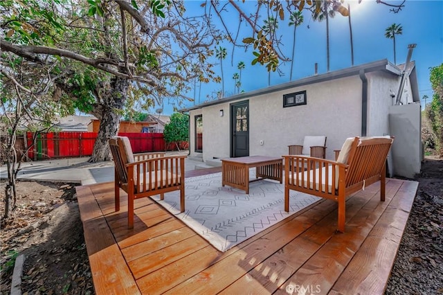 wooden terrace with a patio area and an outdoor living space