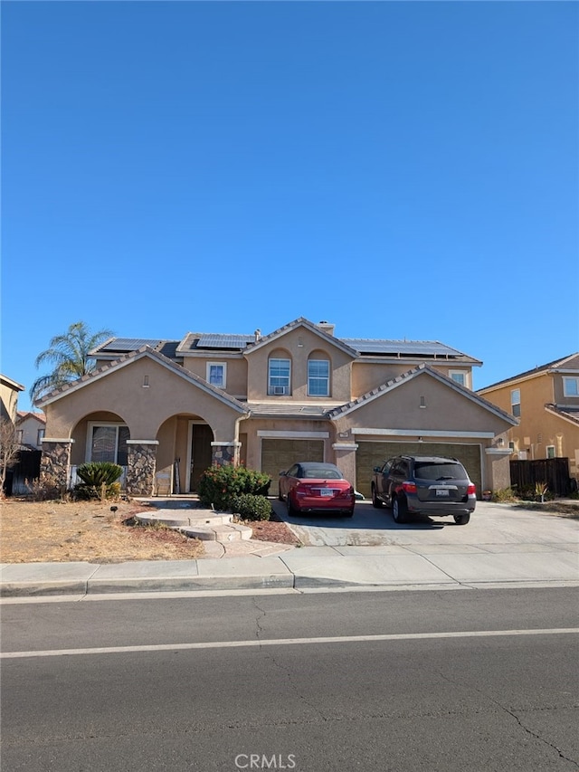 view of front of property with solar panels and a garage