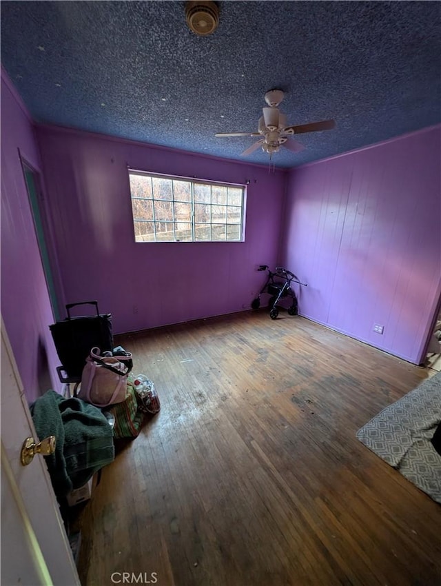 spare room featuring a textured ceiling, ceiling fan, and hardwood / wood-style floors