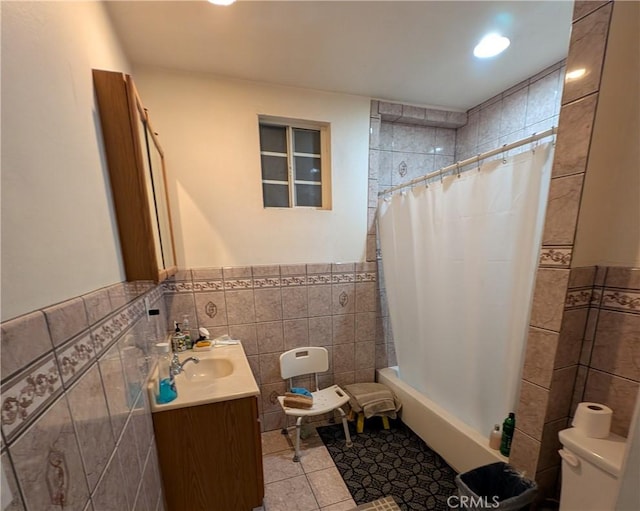 bathroom featuring toilet, vanity, tile walls, and tile patterned floors