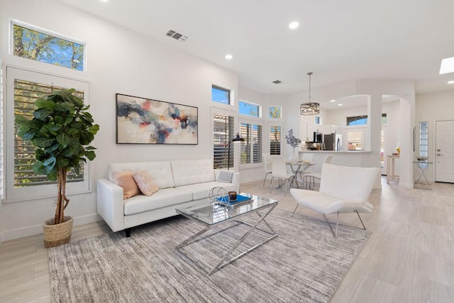 living room with a wealth of natural light and light wood-type flooring