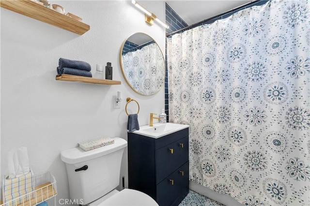 bathroom featuring toilet, vanity, and walk in shower