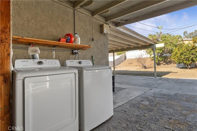 clothes washing area with washing machine and clothes dryer