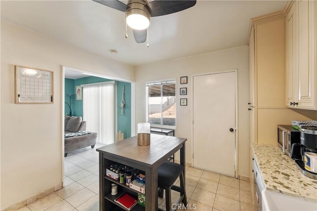 dining area with ceiling fan and light tile patterned floors