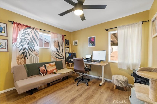 office area with light wood-type flooring and ceiling fan