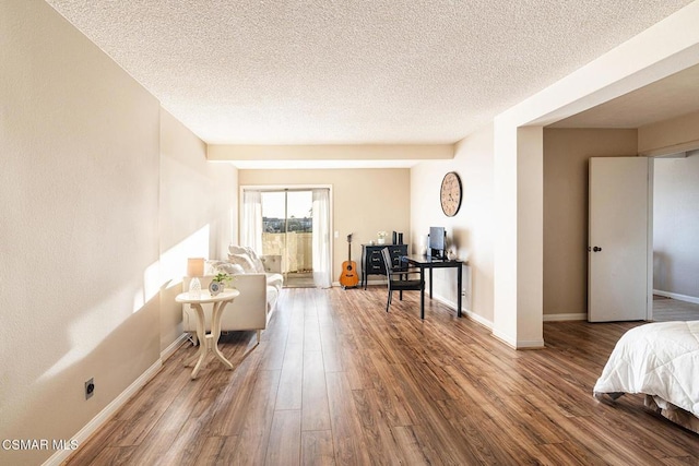 bedroom with hardwood / wood-style flooring and a textured ceiling