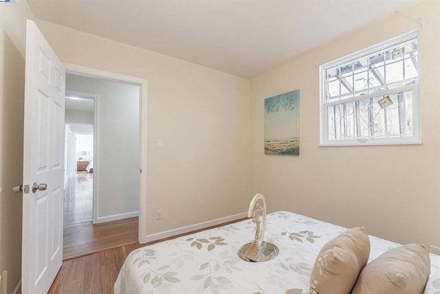 bedroom with hardwood / wood-style floors