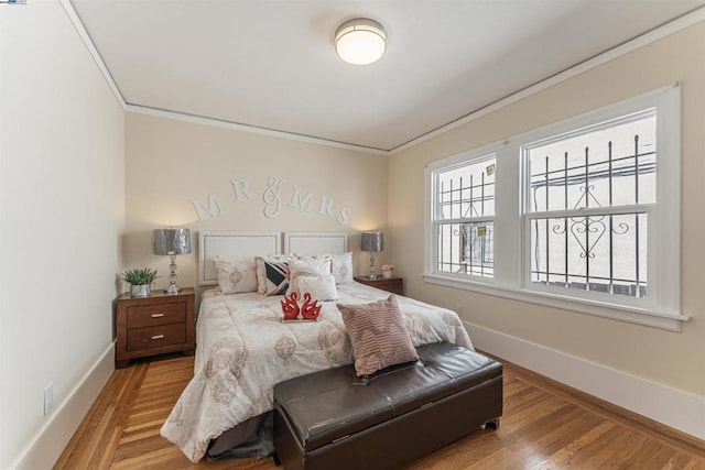 bedroom with crown molding and wood-type flooring