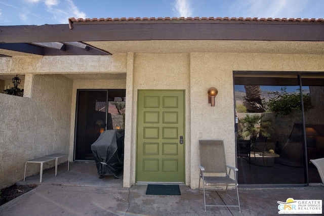 entrance to property with a patio