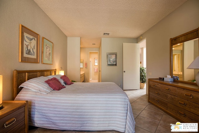 tiled bedroom featuring connected bathroom and a textured ceiling