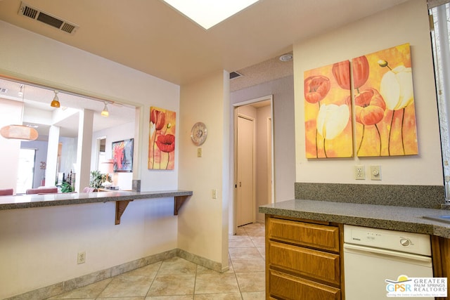 kitchen with light tile patterned floors and rail lighting