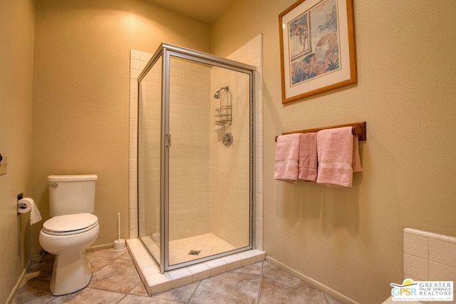 bathroom with tile patterned flooring, toilet, and walk in shower