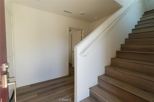 stairway with hardwood / wood-style flooring