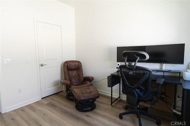 home office with light hardwood / wood-style flooring