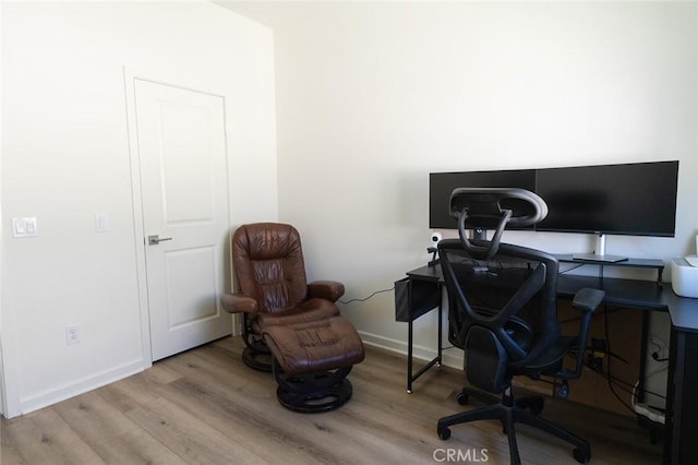 home office featuring baseboards and wood finished floors