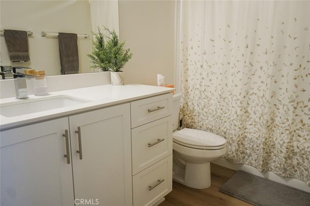 bathroom featuring hardwood / wood-style floors, vanity, and toilet