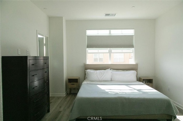 bedroom featuring dark hardwood / wood-style flooring